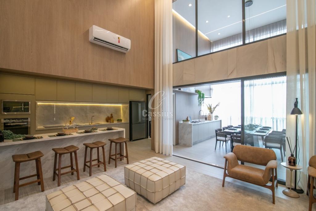 Vista do living do apartamento decorado com cozinha gourmet e área de jantar na varanda